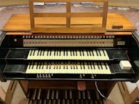 a wooden organ is sitting in a room